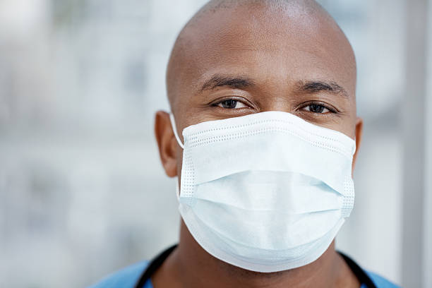 Don't worry, your surgeon knows what he's doing Closeup of an African-American surgeon wearing a surgical mask - portrait nurse face stock pictures, royalty-free photos & images