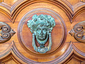 istock Door knocker like antique head on the entrance of a house on Malta. 1321277523