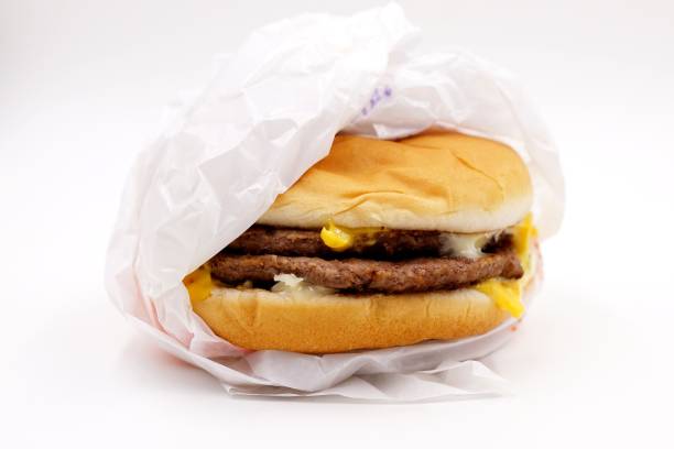 Double cheeseburger Double cheeseburger burger wrapped in paper stock pictures, royalty-free photos & images