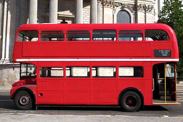 Double Decker bus in London Side view of an empty red Route Master bus in London double decker bus stock pictures, royalty-free photos & images