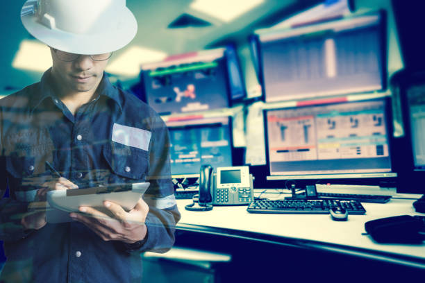 Double exposure of  Engineer or Technician man in working shirt  working with tablet in control room of oil and gas platform or plant industrial for monitor process, business and industry concept stock photo