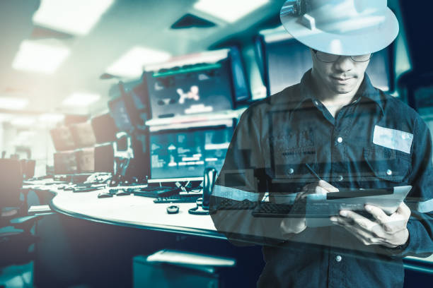 Double exposure of  Engineer or Technician man in working shirt  working with tablet in control room of oil and gas platform or plant industrial for monitor process, business and industry concept stock photo