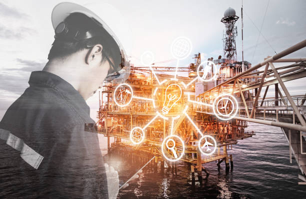 Double exposure of Engineer or Technician man with digital icon operated platform or plant by using tablet with offshore oil and gas platform background for industry business concept. stock photo