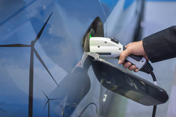 Double exposure of EV charging station for electric car in concept of green sustainable energy produced from renewable resources to supply to charger station in order to reduce CO2 emission . stock photo