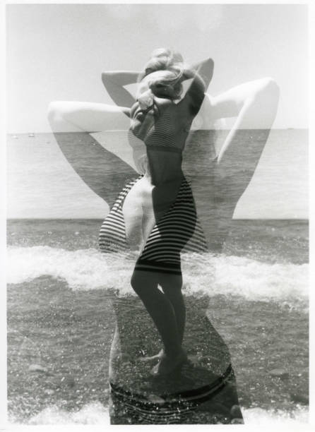 Double multiple exposure: a girl sunbathes on the seashore. stock photo