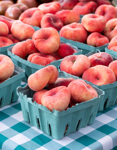 Doughnut peaches at an outdoor market stock photo