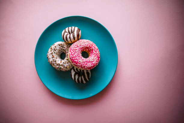 Doughnuts on blue plate stock photo