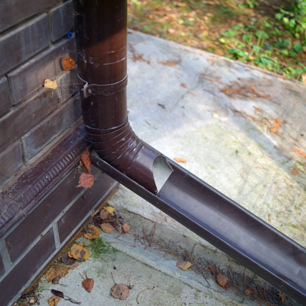 downspout mounted on a brick wal stock photo