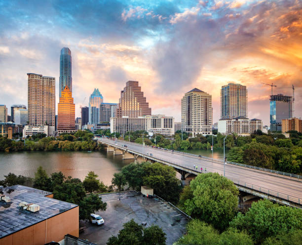 Downtown Austin skyline at sunset elevated view with Colorado river Downtown Austin skyline at sunset elevated view with Colorado river. The view includes several modern office and apartment towers. austin texas stock pictures, royalty-free photos & images