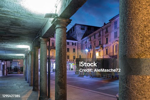istock Downtown deserted city street scene at night. Lecco, Italy 1295427385