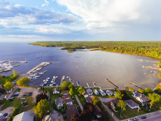 Downtown Fish Creek and Peninsula State Park in Door County Wisconsin by Aerial Drone Aerial drone photography showing downtown Fish Creek and its marina, along with Peninsula State Park in Door County, Wisconsin peninsula stock pictures, royalty-free photos & images