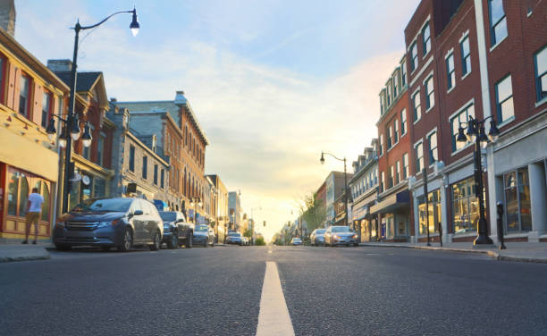Downtown Kingston Ontario at Sunset Road centreline in focus with downtown Kingston, Ontario in background. Downtown Kingston Ontario Stock Photo. small town stock pictures, royalty-free photos & images