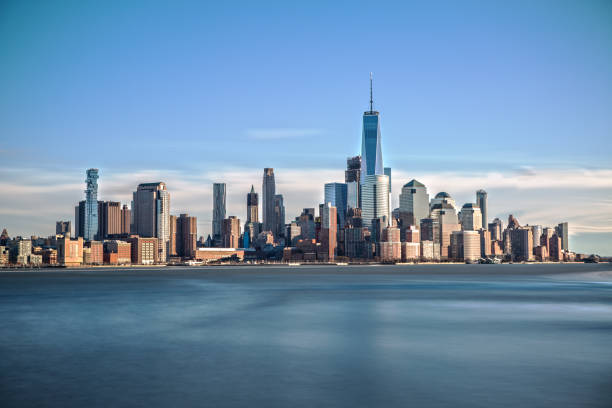 Downtown Manhattan from Hoboken World Trade Center and Downtown Manhattan from Hoboken on a sunny Day empire stock pictures, royalty-free photos & images