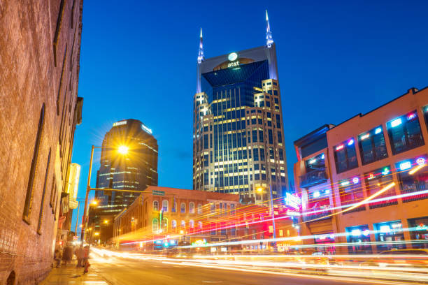 Downtown Nashville Tennessee USA Long exposure stock photograph of the Broadway pub district and office buildings in downtown Nashville, Tennessee, USA, illuminated at night. broadway nashville stock pictures, royalty-free photos & images