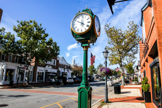 Downtown on a nice day with clock, storefronts, restaurant, and blue sky on Elm Street stock photo