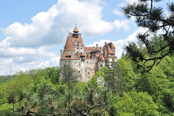 Dracula's Bran Castle in spring season view from the forest stock photo