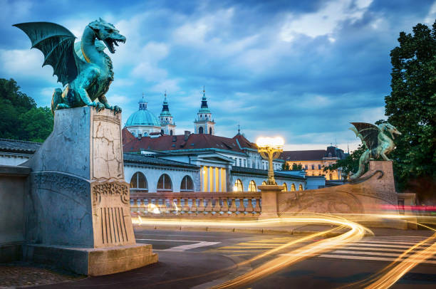 Dragon bridge (Zmajski most), symbol of Ljubljana, capital of Slovenia, Europe. Dragon bridge (Zmajski most), symbol of Ljubljana, capital of Slovenia, Europe. Long exposure. Time lapse. slovenia stock pictures, royalty-free photos & images