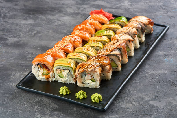 dragon set sushi roll. Green, red, golden with avocado, salmon and eel stock photo