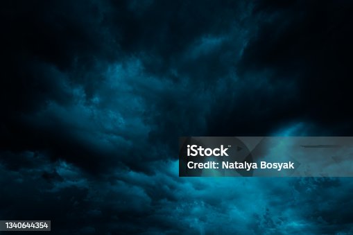 istock Dramatic blue green sky. Gloomy heavy thunderclouds. Dark teal sky background 1340644354