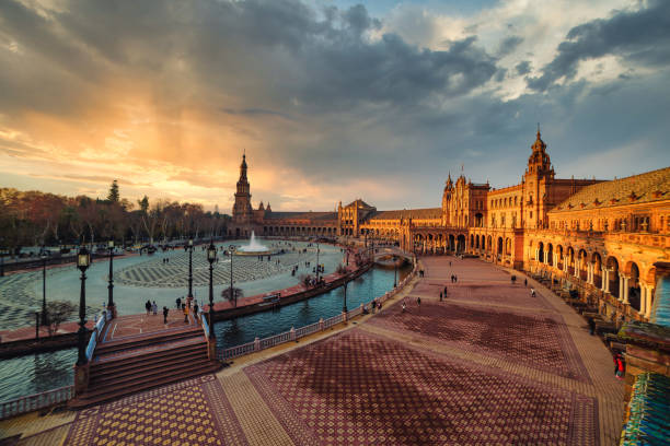 Dramatic scene of Plaza España in Seville at sunset Dramatic scene of Plaza España in Seville at sunset sevilla province stock pictures, royalty-free photos & images