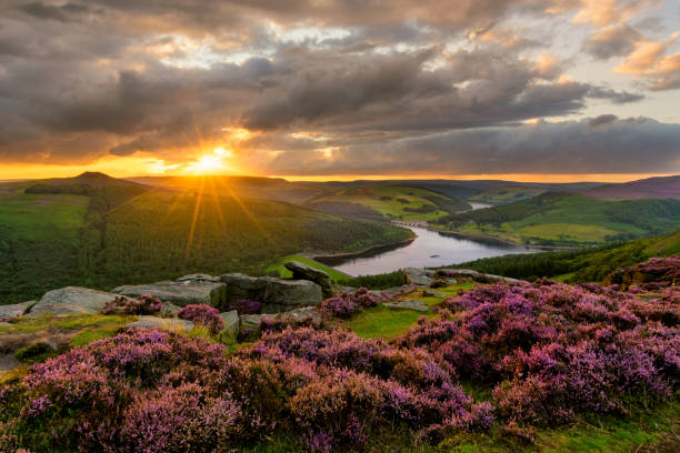 Dramatic Sunset At Bamford Edge In Peak District. Evening sun bursting through dramatic clouds with epic view of Ladybower Reservoir in the Peak District. peak district national park stock pictures, royalty-free photos & images