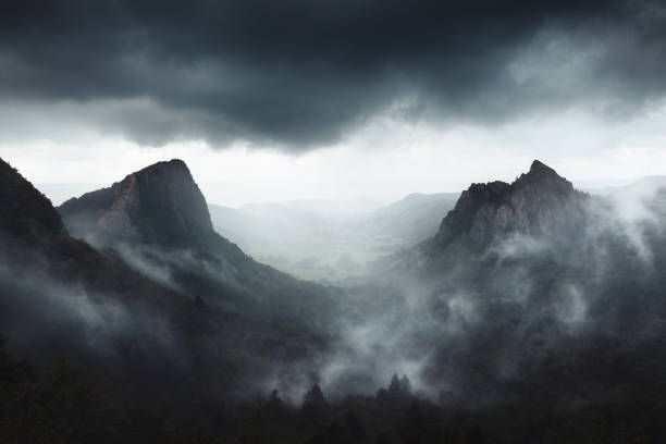 Dramatic weather on Sanadoire and Tuilière rocks in Auvergne province - France Dramatic weather on Sanadoire and Tuilière rocks in Auvergne province - France valley stock pictures, royalty-free photos & images