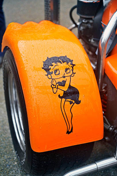 Drawing Betty Boop on the fender of a tricycle stock photo