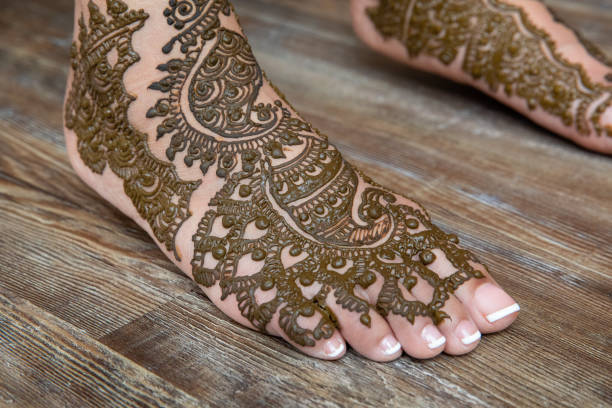 Drawing Henna Art on Indian Bride stock photo