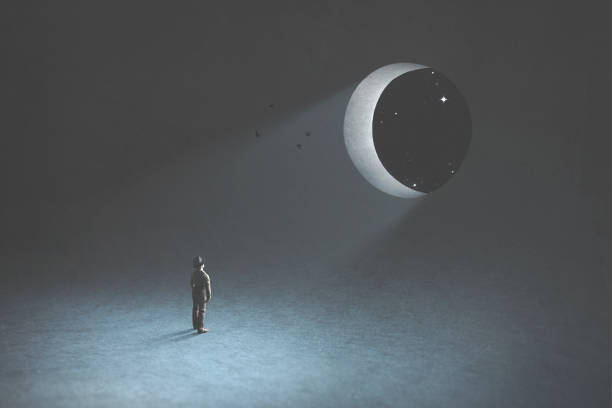 dream and fantasy, man observing the moon in the night that is a hole in the blue dark sky, surreal concept stock photo