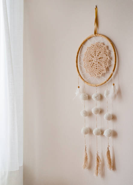 Dream catcher hanging on a boho bedroom  wall stock photo