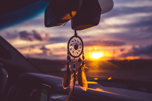 dream catcher on car over blurred highway background. stock photo