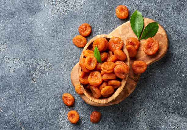 Dried apricots on gray background. Copy space for text. Top view. Dried apricots on gray background. Copy space for text. Top view. dried food photos stock pictures, royalty-free photos & images