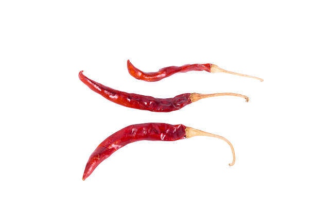 dried chili peppers on white background stock photo