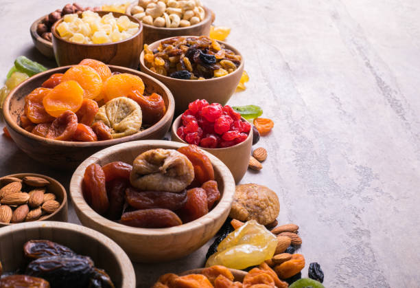 Dried fruits and nuts mix in a wooden bowl. Assortment of candied fruits. Judaic holiday Tu Bishvat. Copy space stock photo