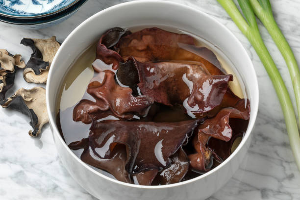 Dried jews ear mushrooms soaking in a bowl stock photo