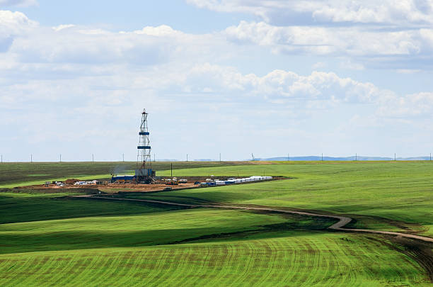 Drilling rig among agricultural fields. View from above stock photo