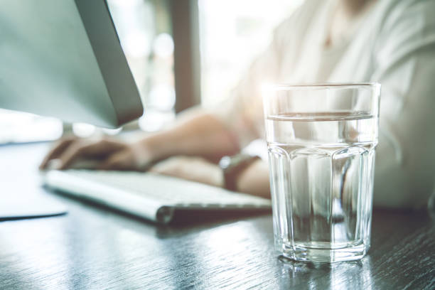 Drink clean room temperature water during working time for healthy and stay hydrated at work. Drink clean room temperature water during working time for healthy and stay hydrated at work. stay hydrated stock pictures, royalty-free photos & images