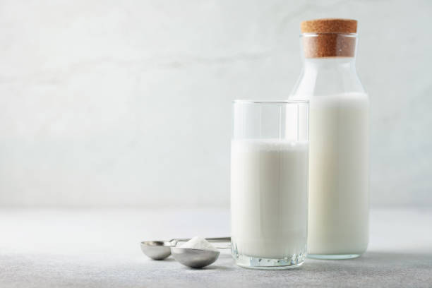 Drink from dry vegan vegetable milk in a glass and bottle. stock photo