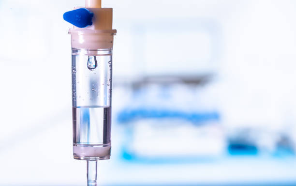 Dripping medical perfusion close up equipment in clinic background. Saline Solution IV Drip Fluid for Infusion in Hospital. Intravenous infusion tube equipment in hospital. antiviral treatment  infusion therapy stock pictures, royalty-free photos & images