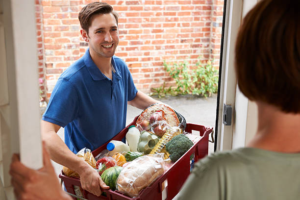 Driver Delivering Online Grocery Shopping Order stock photo