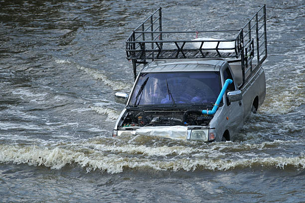 Driving Car in Flood Water at Bangkok, Thailand stock photo