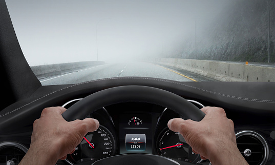 Driving in fog weather. View from the driver angle