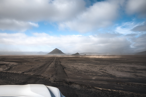 View from the car on a gravel road (F-road) leading through the volcanic landscape (Maelifell - the Central Highlands, Iceland).