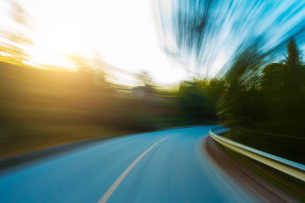 Driving motion blur in forest road stock photo