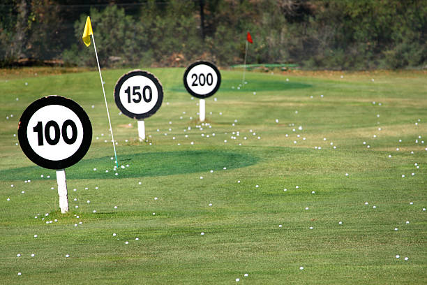 Driving Range Golf balls and signs at a driving range 100 yard stock pictures, royalty-free photos & images