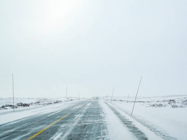 Driving through blizzard snowstorm with black ice on road, Norway. stock photo