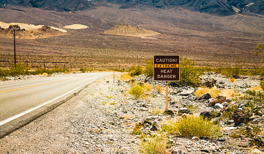 Extreme heat danger warning sign seen while driving through Death Valley National Park in California, USA.