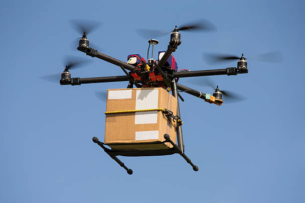 drone carrying parcel - drone stockfoto's en -beelden