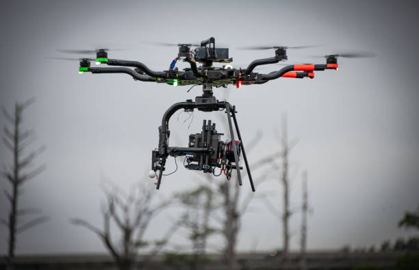 Drone Mounted Digital Cinema Camera A digital cinema camera is affixed to a heavy duty drone. multicopter stock pictures, royalty-free photos & images