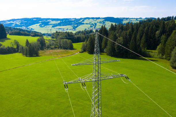Drone photography of electricity pylons in the countryside. Electricity pylon in the middle of a meadow. stock photo